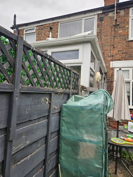 Neighbour attaching things to our fence?