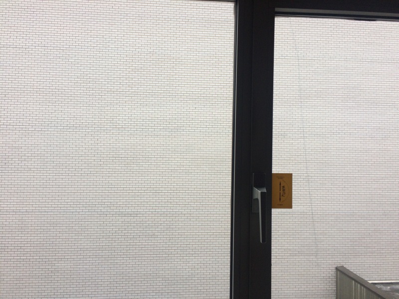 Hotel Room Windows Facing a Concrete Wall