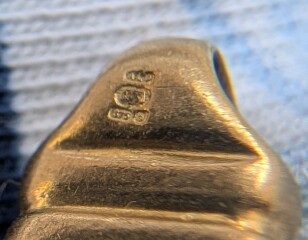 Hallmark on gold bracelet