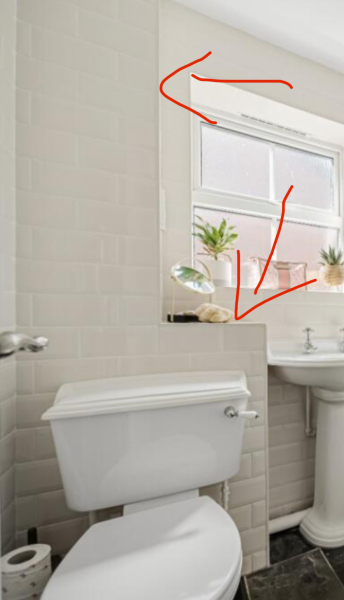 What is behind this section in bathroom?