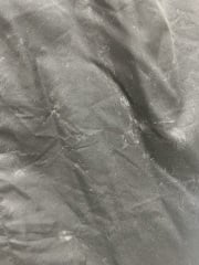 Grey stains on black dress after washing - help