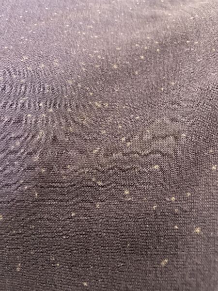 What caused these tiny white spots on my cotton sweater?