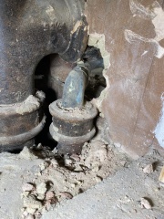 Help! Shower waste level trouble - how to adjust this copper to cast iron junction? (Pics)