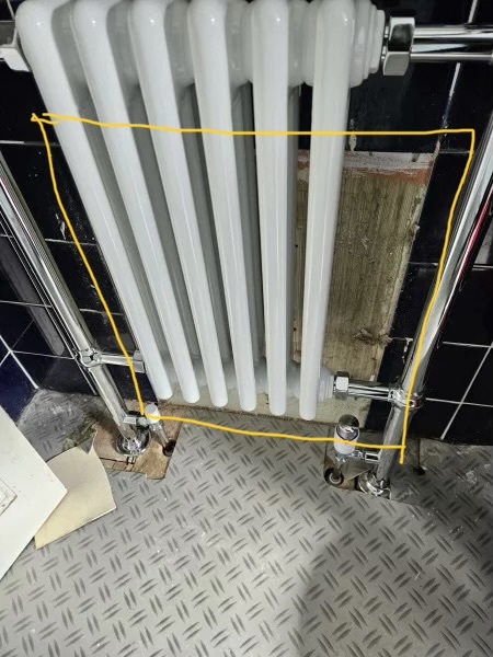 How to decorate untiled patch behind new bathroom radiator without removing it?