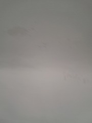 Damp patches on attic bedroom ceiling after wind and rain