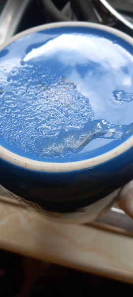 Dishwasher leaving sandy food residue on cups on the top shelf