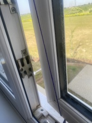 How can I keep my window partly open in the wind?