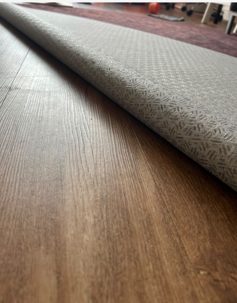 Rug backing has made LVT floor slippery, how can I clean it?