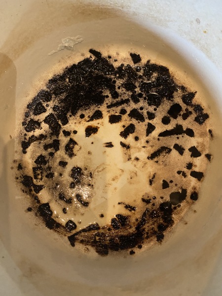 How do I remove burnt food from a Le Crousette pan?