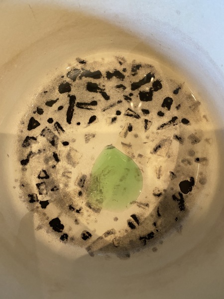 How do I remove burnt food from a Le Crousette pan?