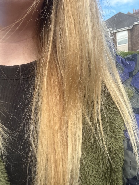 How can I tone down orange highlights without bleaching again?