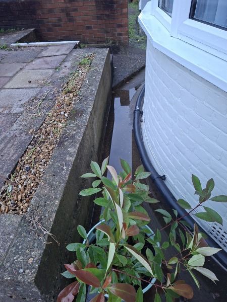 How can I improve drainage on a concrete front area?
