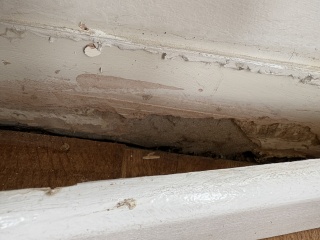 Who should I call about exposed brick behind loose skirting?
