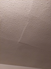 Cracks under wallpaper in ceiling
