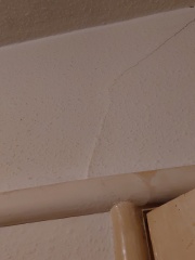 Diagonal crack above internal door and into ceiling, should I worry?