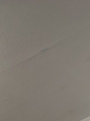 Cracks under wallpaper in ceiling