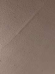 Cracks under wallpaper in ceiling