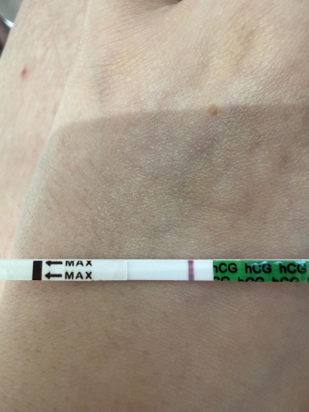 Possible faint positive at 9dpo or just an evaporation line?