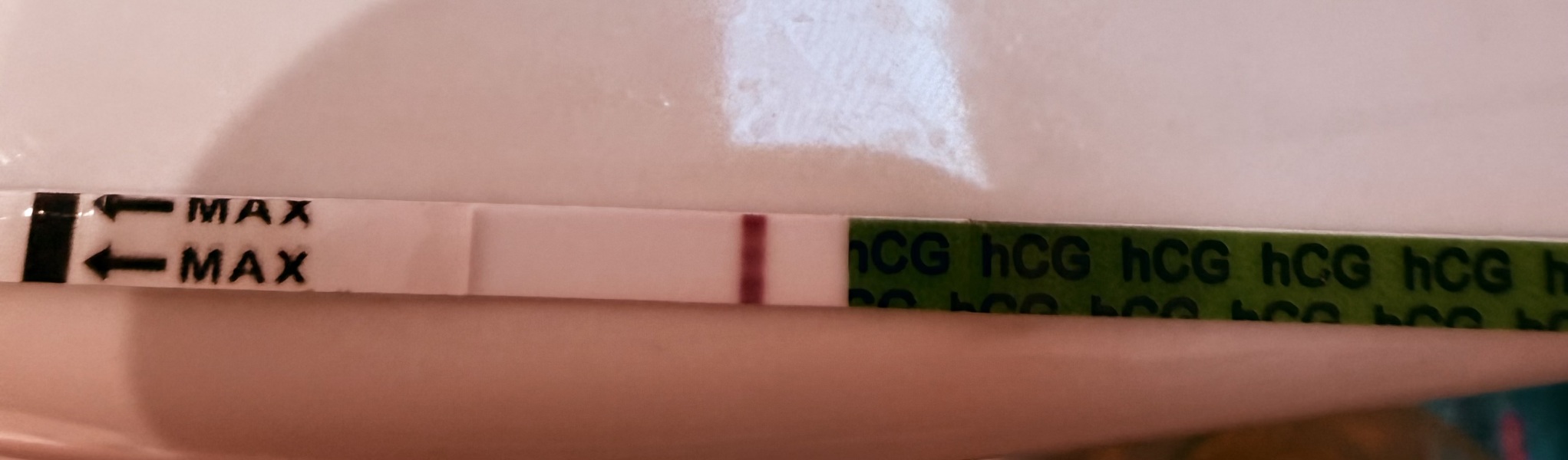 Possible faint positive at 9dpo or just an evaporation line?