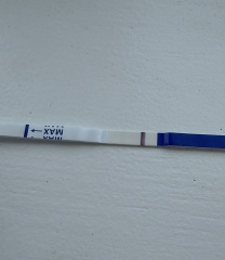Possible faint positive at 9dpo or just an evaporation line?