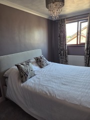 Plum walls and grey bedroom: throw and wall art ideas