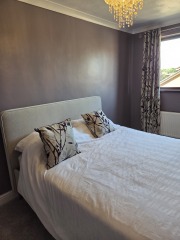 Plum walls and grey bedroom: throw and wall art ideas