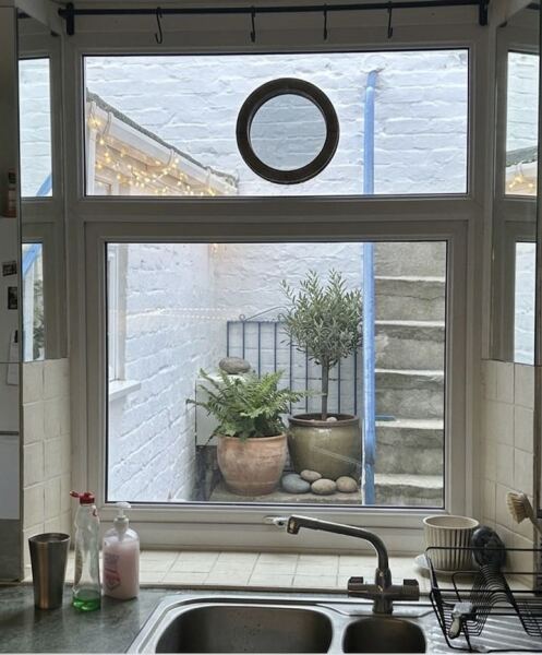 Ideas to improve a basement kitchen window view without losing light