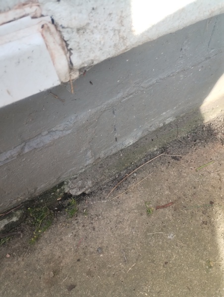 What should I use between patio slabs beside the house wall?