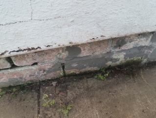 What should I use between patio slabs beside the house wall?