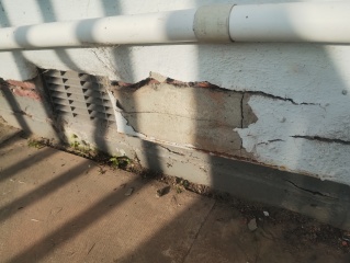 What should I use between patio slabs beside the house wall?