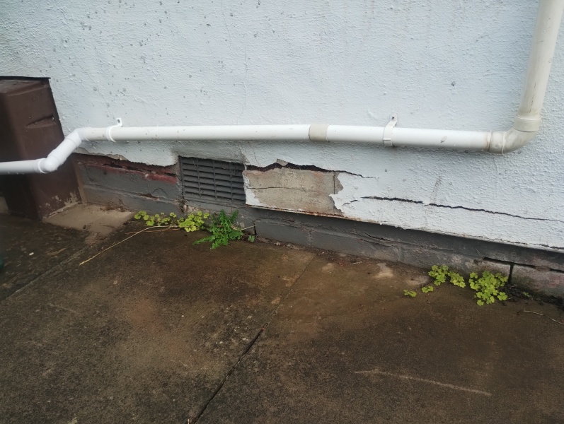 What should I use between patio slabs beside the house wall?