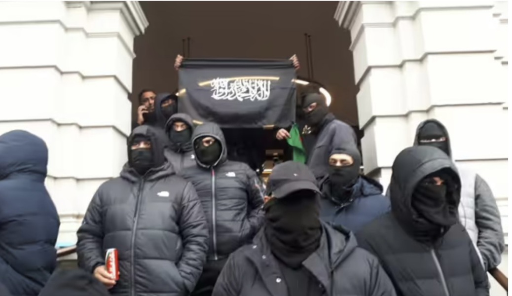 Masked men at Dover - KKK vibes