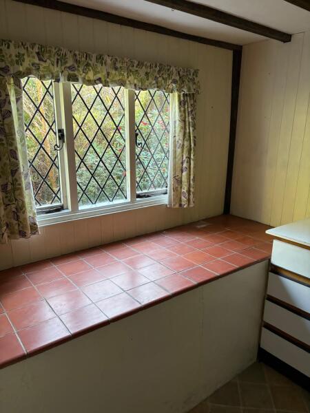Why would an old utility room have a large concrete slab full of dirt?