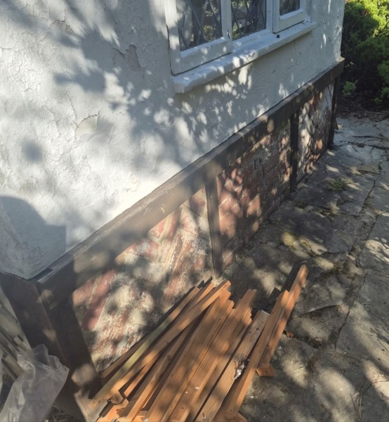 Why would an old utility room have a large concrete slab full of dirt?